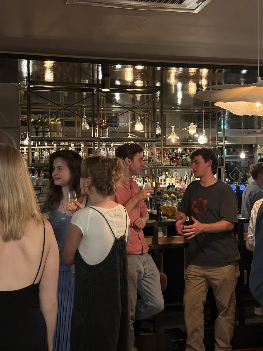 Guests talking at the bar at The Reach Riverside, a family-run restaurant in Fulham Reach