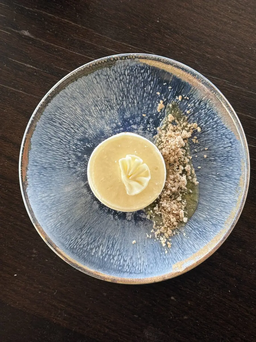 Vanilla cheesecake on a blue glazed plate